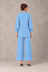 Back view of sky blue linen shirt and wide-leg trousers