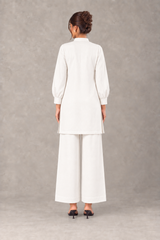 Side view of Pearl linen outfit showing straight-cut shirt
